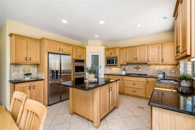 30 Sunswept Mesa, Aliso Viejo, CA 92656 - kitchen with appliances with stainless steel finishes, a kitchen island, tasteful backsplash, dark stone countertops, and light brown cabinets