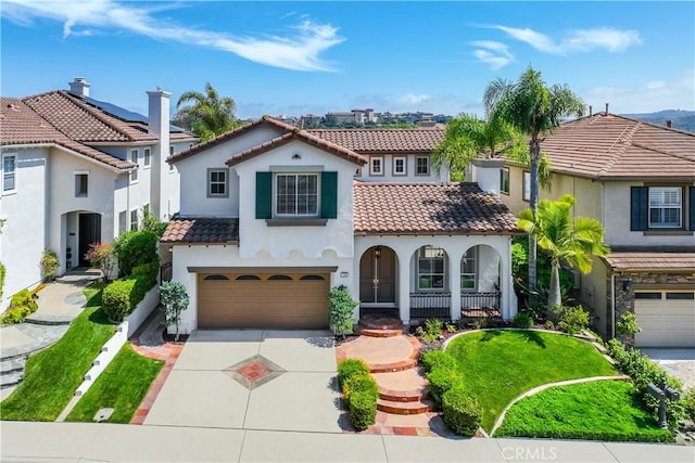 30 Sunswept Mesa, Aliso Viejo, CA 92656 - mediterranean / spanish-style house with a tiled roof, a garage, driveway, stucco siding, and covered porch