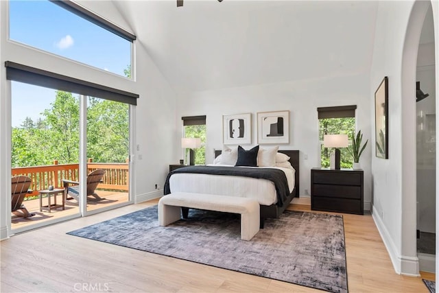 1019 Pintail Cir, Lake Arrowhead, CA 92352 - bedroom featuring high vaulted ceiling, access to outside, multiple windows, light wood-style flooring, and arched walkways