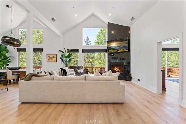 1019 Pintail Cir, Lake Arrowhead, CA 92352 - living room with high vaulted ceiling, a fireplace, and light wood-style flooring