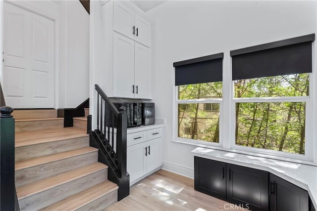 1019 Pintail Cir, Lake Arrowhead, CA 92352 - stairs featuring wood finished floors and baseboards