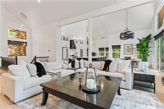 1019 Pintail Cir, Lake Arrowhead, CA 92352 - living area with high vaulted ceiling, light wood-type flooring, and a chandelier