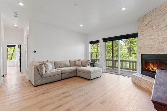 1019 Pintail Cir, Lake Arrowhead, CA 92352 - living area with light wood finished floors, a stone fireplace, and recessed lighting
