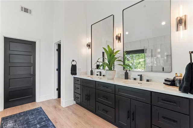 1019 Pintail Cir, Lake Arrowhead, CA 92352 - full bath with double vanity, wood finished floors, and a towering ceiling