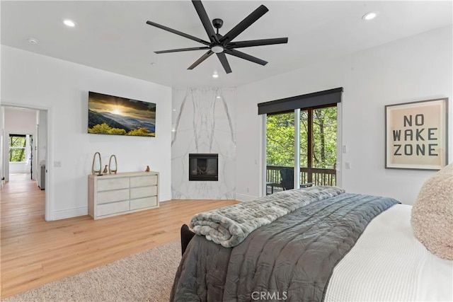 1019 Pintail Cir, Lake Arrowhead, CA 92352 - bedroom featuring access to outside, wood finished floors, recessed lighting, multiple windows, and a fireplace