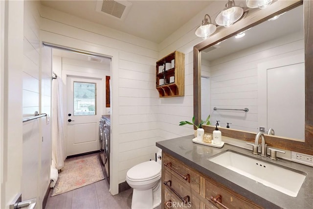 2289 Falcon Ridge Ln, Los Osos, CA 93402 - bathroom with independent washer and dryer, vanity, wood walls, and tile patterned flooring