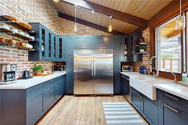 2289 Falcon Ridge Ln, Los Osos, CA 93402 - kitchen with appliances with stainless steel finishes, open shelves, light wood-type flooring, decorative light fixtures, and brick wall