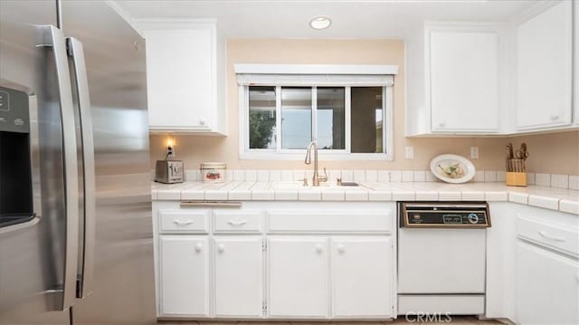 8452 Hawthorne St, Rancho Cucamonga, CA 91701 - kitchen featuring stainless steel fridge with ice dispenser, white dishwasher, a sink, white cabinetry, and light countertops