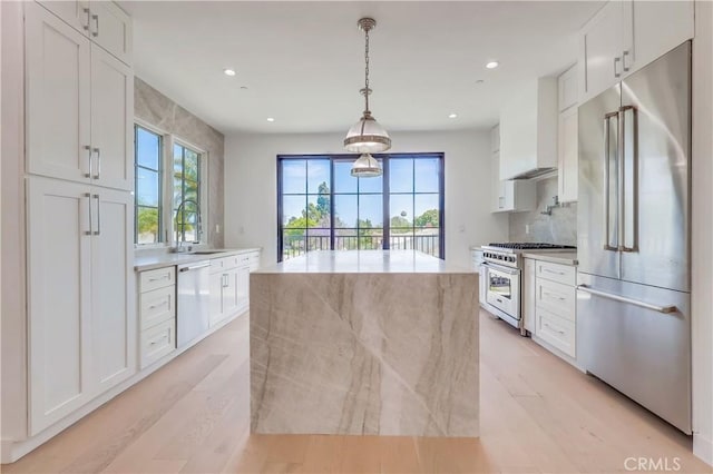 3803 Berryman Ave, Los Angeles, CA 90066 - kitchen with high quality appliances, wall chimney exhaust hood, white cabinets, plenty of natural light, and recessed lighting