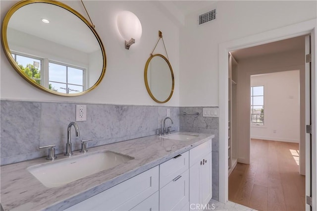 3803 Berryman Ave, Los Angeles, CA 90066 - bathroom featuring double vanity, tile walls, wood finished floors, and wainscoting