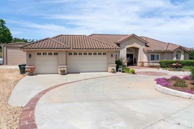 30646 Red Hawk Rd, Valley Center, CA 92082 - mediterranean / spanish-style home with stucco siding, a tiled roof, an attached garage, and driveway