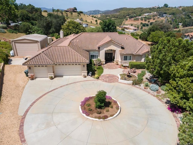 30646 Red Hawk Rd, Valley Center, CA 92082 - mediterranean / spanish-style house featuring stucco siding, a tile roof, an attached garage, and concrete driveway