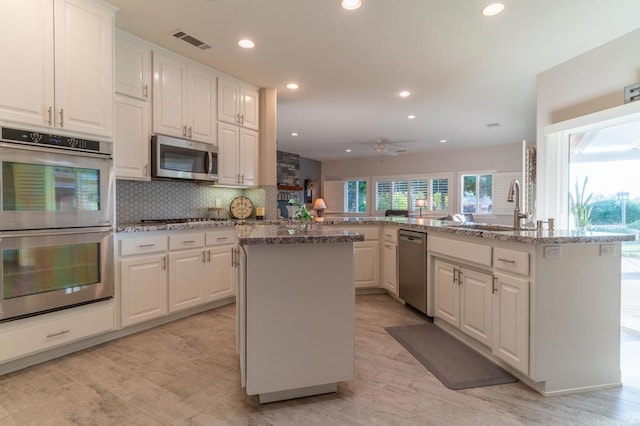 30646 Red Hawk Rd, Valley Center, CA 92082 - kitchen with stainless steel appliances, a kitchen island, recessed lighting, backsplash, and white cabinets