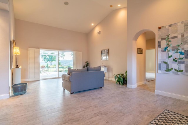 30646 Red Hawk Rd, Valley Center, CA 92082 - living area featuring high vaulted ceiling, arched walkways, wood finished floors, and recessed lighting