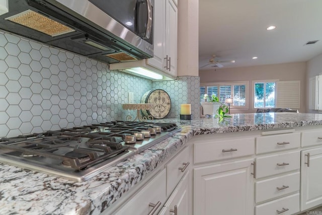 30646 Red Hawk Rd, Valley Center, CA 92082 - kitchen featuring appliances with stainless steel finishes, ceiling fan, backsplash, white cabinets, and light stone counters