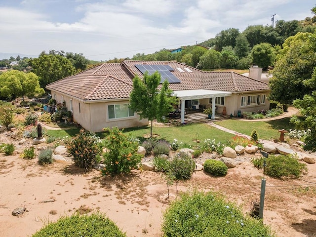 30646 Red Hawk Rd, Valley Center, CA 92082 - view of front facade featuring a tiled roof, solar panels, a front yard, stucco siding, and a chimney