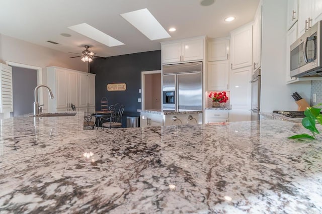 30646 Red Hawk Rd, Valley Center, CA 92082 - kitchen featuring appliances with stainless steel finishes, light stone counters, a ceiling fan, and recessed lighting