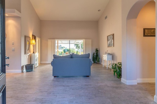 30646 Red Hawk Rd, Valley Center, CA 92082 - living area with arched walkways, wood finished floors, and a towering ceiling