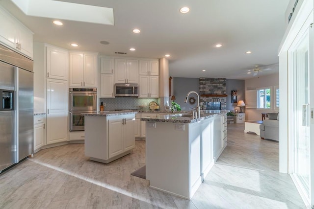 30646 Red Hawk Rd, Valley Center, CA 92082 - kitchen featuring stainless steel appliances, a kitchen island with sink, ceiling fan, white cabinets, and recessed lighting
