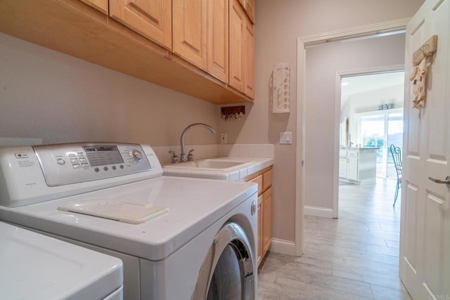 30646 Red Hawk Rd, Valley Center, CA 92082 - laundry area featuring cabinet space, washing machine and dryer, and light wood finished floors
