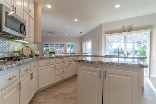 30646 Red Hawk Rd, Valley Center, CA 92082 - kitchen featuring stainless steel appliances, a ceiling fan, recessed lighting, decorative backsplash, and white cabinetry