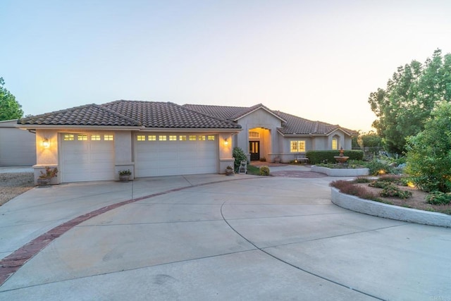 30646 Red Hawk Rd, Valley Center, CA 92082 - mediterranean / spanish house with concrete driveway, a garage, stucco siding, and a tiled roof