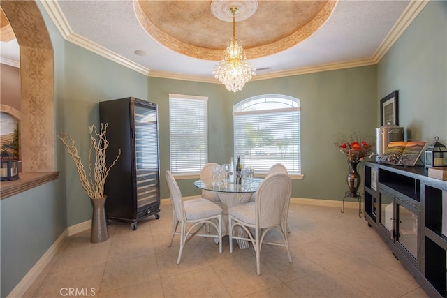 41380 La Sierra Rd, Temecula, CA 92591 - dining area featuring a chandelier, baseboards, a raised ceiling, ornamental molding, and arched walkways
