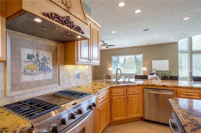 41380 La Sierra Rd, Temecula, CA 92591 - kitchen featuring stainless steel appliances, premium range hood, a sink, light stone countertops, and recessed lighting