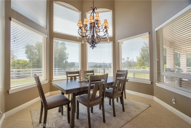 41380 La Sierra Rd, Temecula, CA 92591 - dining room featuring light tile patterned flooring, a chandelier, baseboards, and a towering ceiling