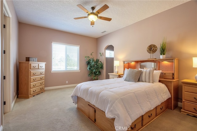 41380 La Sierra Rd, Temecula, CA 92591 - bedroom featuring light carpet, arched walkways, baseboards, a ceiling fan, and a textured ceiling