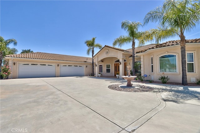 41380 La Sierra Rd, Temecula, CA 92591 - mediterranean / spanish house featuring concrete driveway, a tile roof, stucco siding, and an attached garage