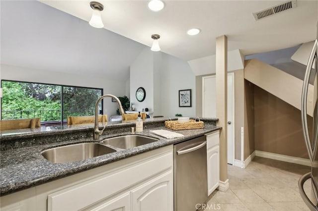 2787 Pine Creek Cir, Fullerton, CA 92835 - kitchen featuring stainless steel appliances, a sink, vaulted ceiling, dark stone countertops, and light tile patterned flooring