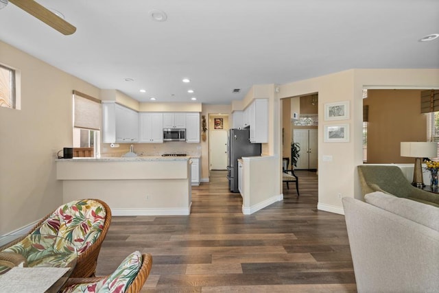 11964 Ashley Pl, San Diego, CA 92128 - kitchen with stainless steel appliances, dark wood-style floors, a peninsula, white cabinets, and a ceiling fan