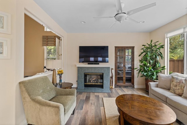 11964 Ashley Pl, San Diego, CA 92128 - living room with wood finished floors, a high end fireplace, recessed lighting, and ceiling fan
