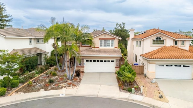 11964 Ashley Pl, San Diego, CA 92128 - view of front facade featuring concrete driveway, a tile roof, and roof mounted solar panels