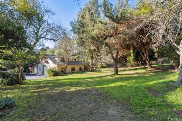 10880 Hess Dr, La Mesa, CA 91941 - view of green lawn featuring a garage and asphalt driveway