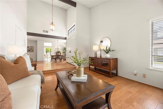 77 S Havenwood Unit 27, Irvine, CA 92614 - living area featuring healthy amount of natural light, high vaulted ceiling, and light wood-type flooring