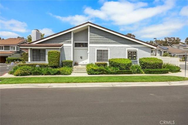 77 S Havenwood Unit 27, Irvine, CA 92614 - mid-century inspired home featuring a chimney and stucco siding