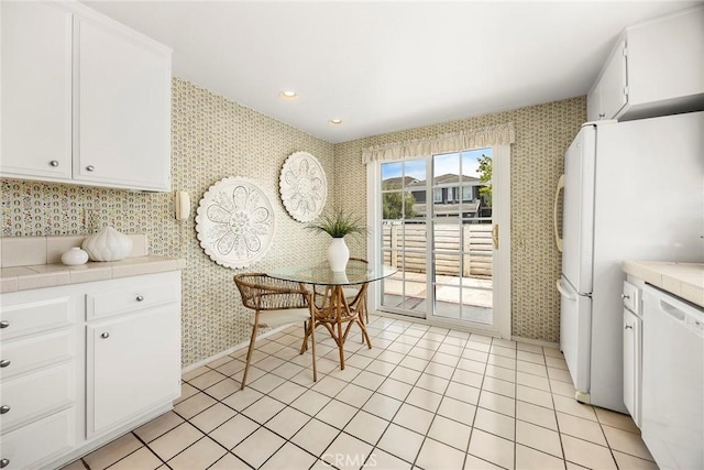 77 S Havenwood Unit 27, Irvine, CA 92614 - kitchen with tile countertops, white appliances, wallpapered walls, white cabinets, and recessed lighting