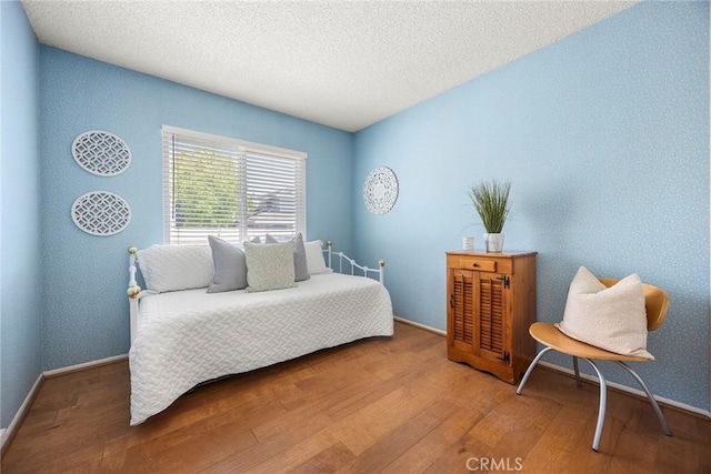 77 S Havenwood Unit 27, Irvine, CA 92614 - bedroom featuring wood finished floors and a textured ceiling