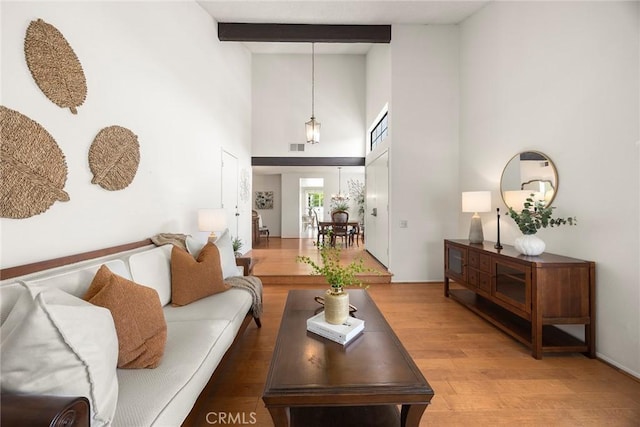77 S Havenwood Unit 27, Irvine, CA 92614 - living area with light wood-style floors, high vaulted ceiling, and beam ceiling