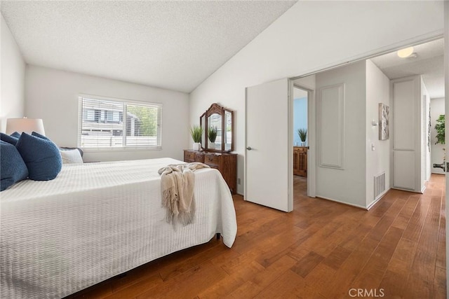77 S Havenwood Unit 27, Irvine, CA 92614 - bedroom with wood finished floors, a textured ceiling, and lofted ceiling