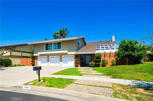 2108 Via Caliente, Fullerton, CA 92833 - view of front of house featuring a garage, driveway, and a chimney