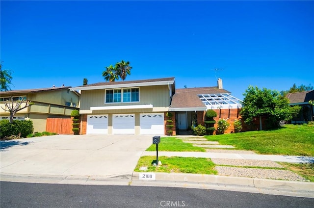 2108 Via Caliente, Fullerton, CA 92833 - view of front of property featuring a garage, concrete driveway, and a front yard