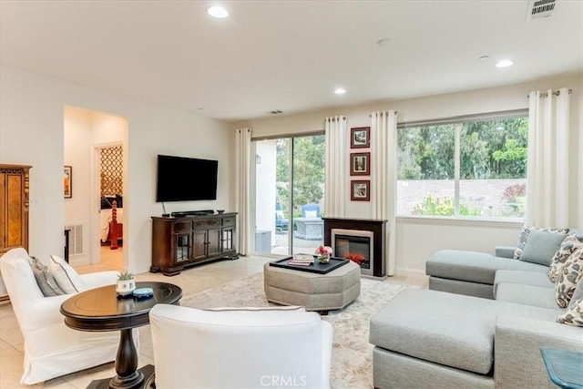 1055 Ford Dr, Nipomo, CA 93444 - living room with recessed lighting, a glass covered fireplace, and light tile patterned floors