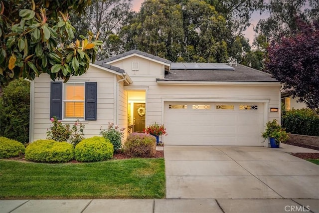 1055 Ford Dr, Nipomo, CA 93444 - view of front of property featuring solar panels, driveway, an attached garage, and a yard