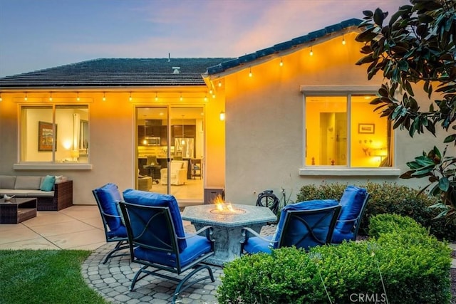 1055 Ford Dr, Nipomo, CA 93444 - patio terrace at dusk with a patio area and an outdoor living space with a fire pit