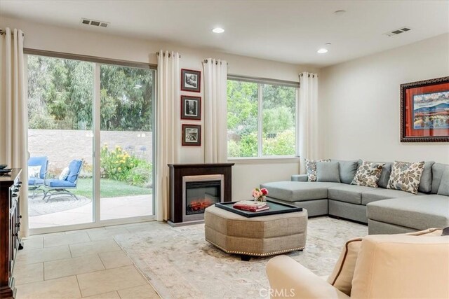 1055 Ford Dr, Nipomo, CA 93444 - living room featuring light tile patterned floors, recessed lighting, and a glass covered fireplace