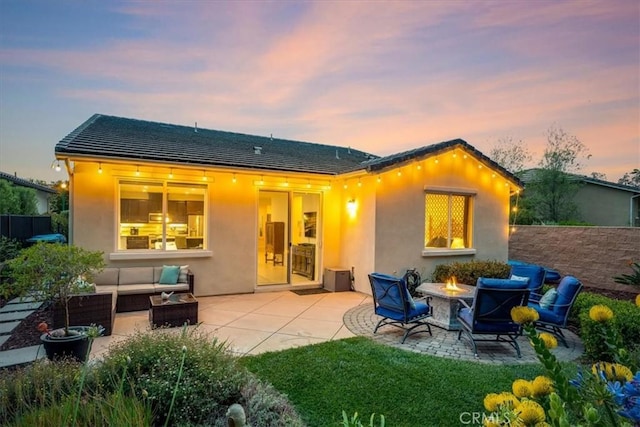 1055 Ford Dr, Nipomo, CA 93444 - back of house featuring a patio area, stucco siding, a tiled roof, and an outdoor living space with a fire pit