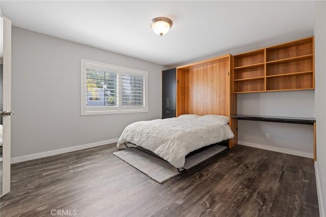 14506 Benefit St Unit 103, Sherman Oaks, CA 91403 - bedroom with dark wood-style flooring and baseboards